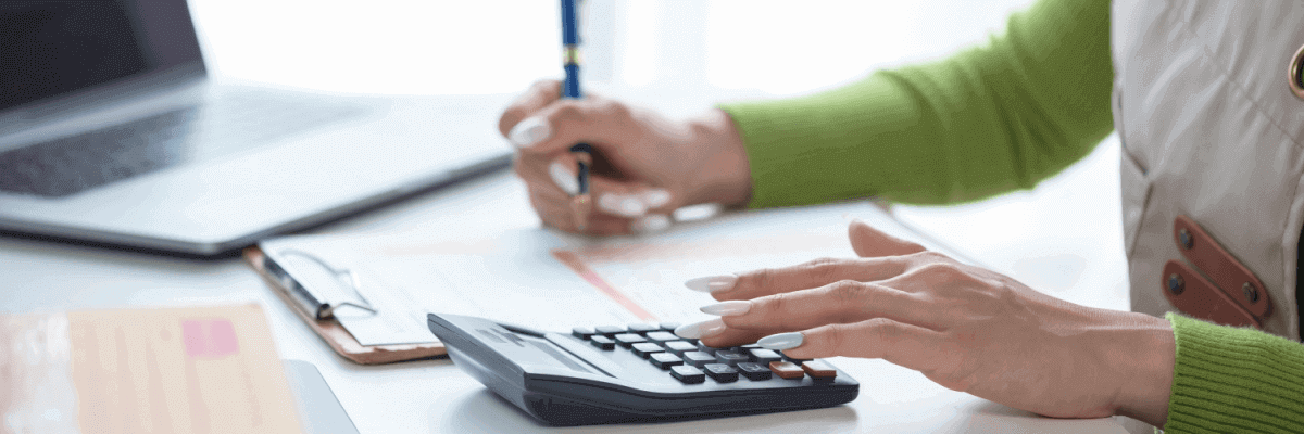 Person with a calculator and pen
