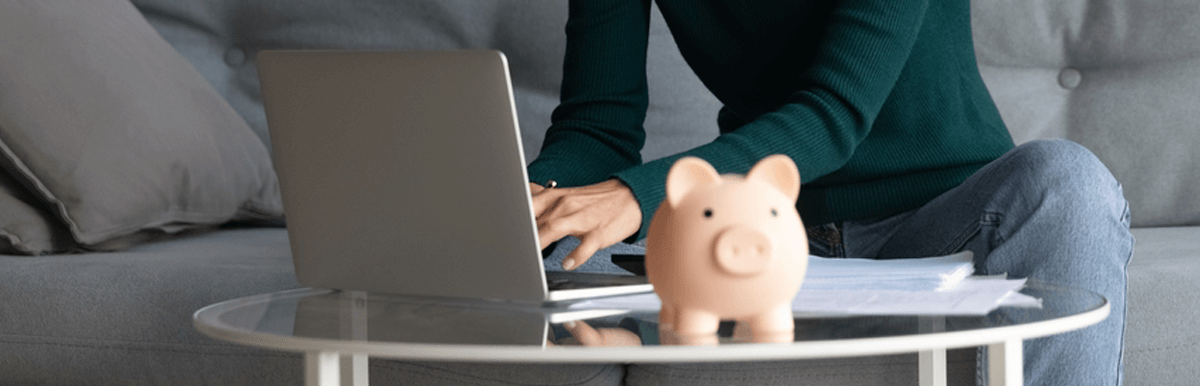 Woman using laptop and piggy bank. NBN prices concept
