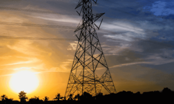 Power poles and lines with sunset