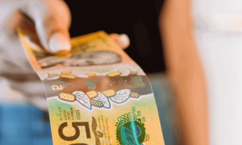 Woman giving $50 note