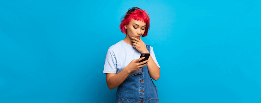 Disappointed young woman using phone. Telstra price change concept